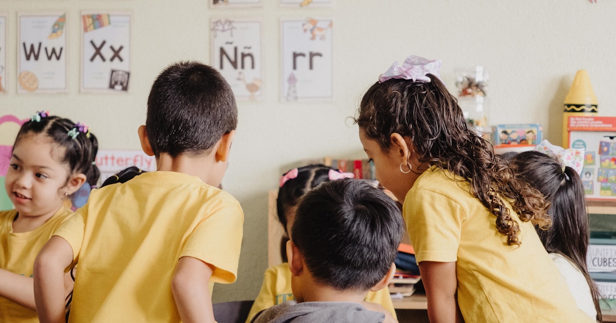 A group of children sitting at desks in a classroom