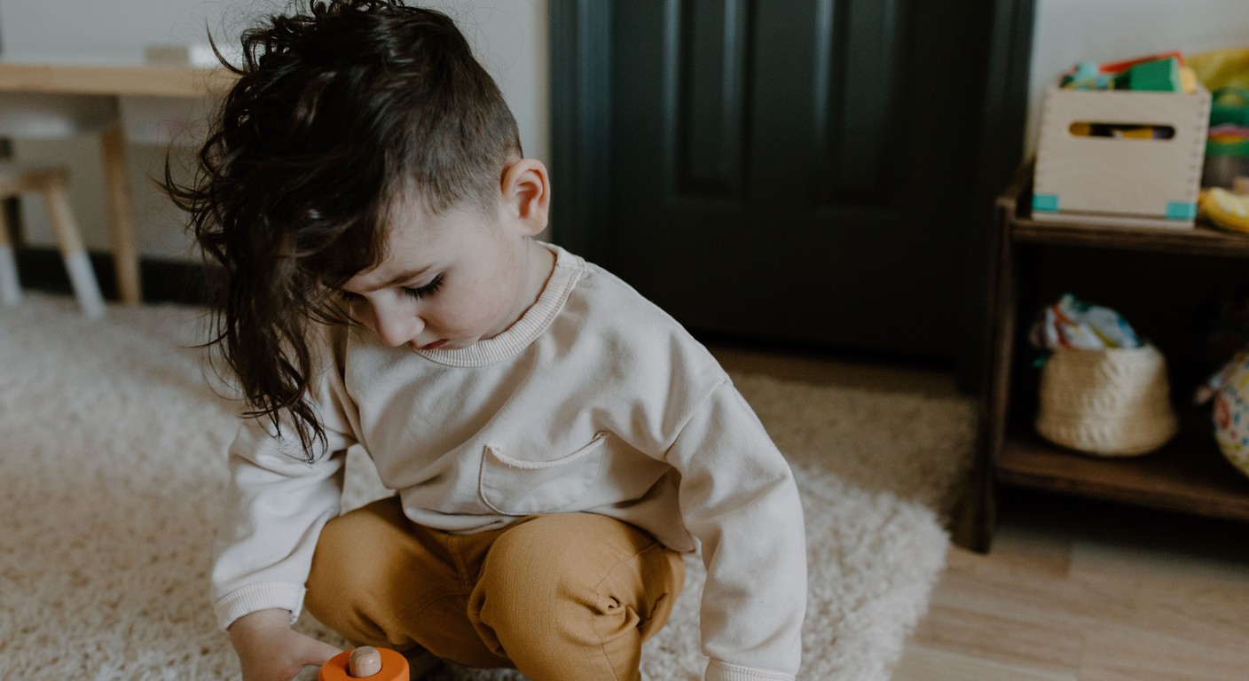 A focused toddler at home exploring and learning