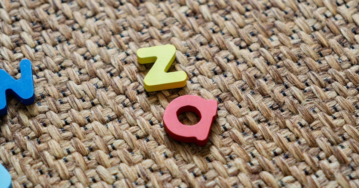 Colorful letters scattered on a textured surface.